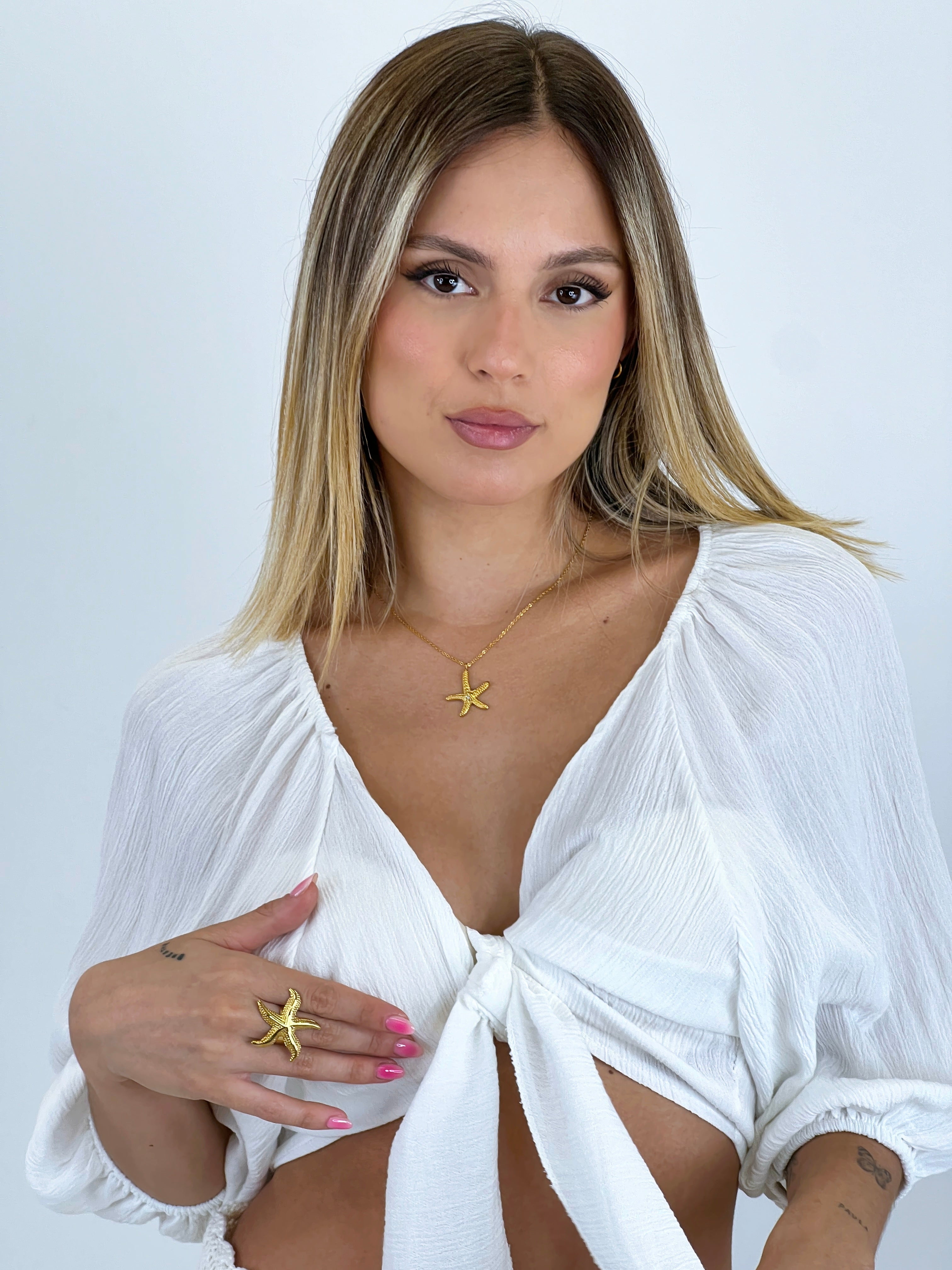 Blusa aperta con nodo